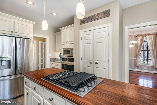 3617 Hidden Acres Way, Partlow, VA 22534 - kitchen with stainless steel appliances, wooden counters, white cabinets, dark wood finished floors, and hanging light fixtures