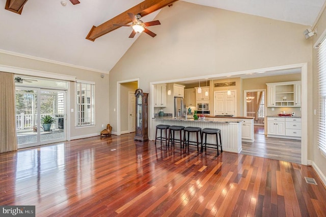 3617 Hidden Acres Way, Partlow, VA 22534 - kitchen featuring a ceiling fan, high vaulted ceiling, appliances with stainless steel finishes, a breakfast bar, and dark wood-type flooring