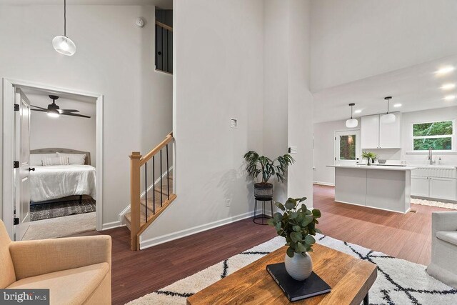 5925 Stubbs Bridge Rd, Mineral, VA 23117 - living area featuring light wood-style floors, a towering ceiling, a ceiling fan, and stairs