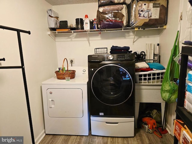 11708 Eisenhower Ln, Fredericksburg, VA 22407 - laundry area featuring wood finished floors and washing machine and dryer