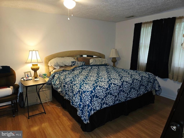 11708 Eisenhower Ln, Fredericksburg, VA 22407 - bedroom featuring wood finished floors and a textured ceiling