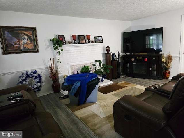 11708 Eisenhower Ln, Fredericksburg, VA 22407 - living room with a fireplace, wood finished floors, and a textured ceiling
