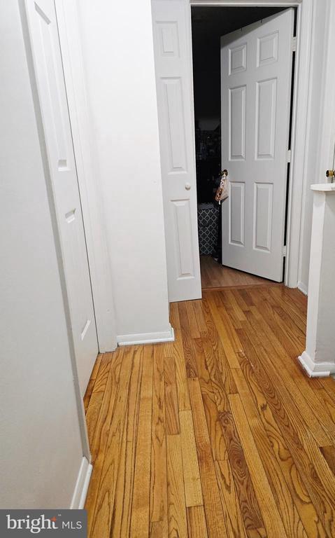 11708 Eisenhower Ln, Fredericksburg, VA 22407 - hallway featuring light wood-type flooring and baseboards