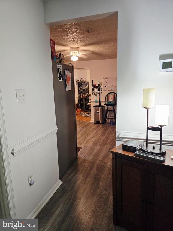 11708 Eisenhower Ln, Fredericksburg, VA 22407 - corridor with dark wood-type flooring and a textured ceiling