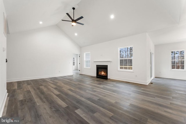 unfurnished living room with a ceiling fan, high vaulted ceiling, a fireplace with flush hearth, recessed lighting, and baseboards