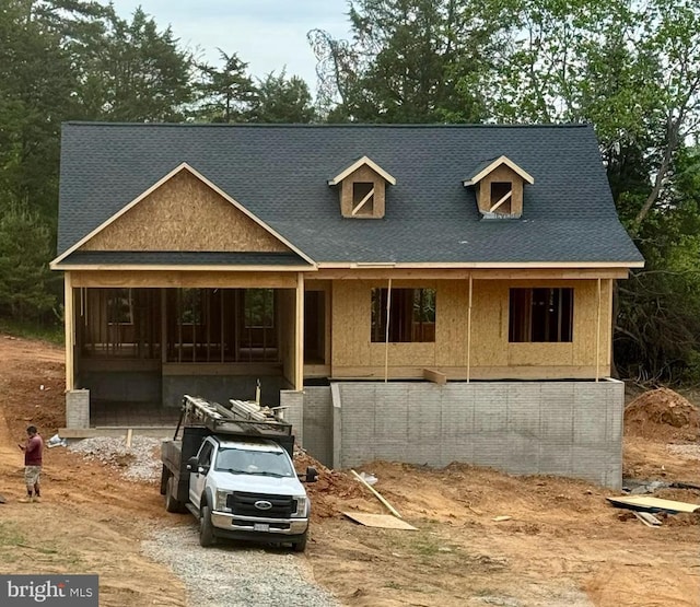 view of front of home featuring roof with shingles