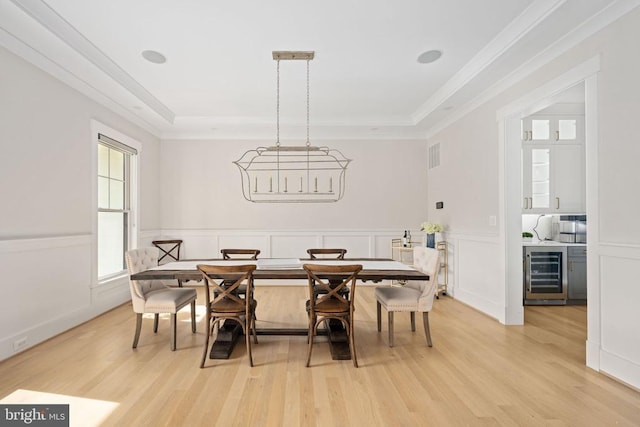 11606 Little Bay Harbor Way, Spotsylvania, VA 22551 - dining room with wine cooler, light wood finished floors, a raised ceiling, ornamental molding, and wainscoting