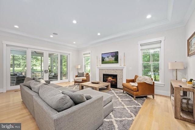 11606 Little Bay Harbor Way, Spotsylvania, VA 22551 - living area featuring a glass covered fireplace, light wood-style flooring, ornamental molding, recessed lighting, and french doors