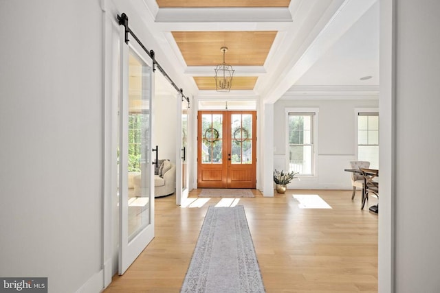 11606 Little Bay Harbor Way, Spotsylvania, VA 22551 - entryway with a tray ceiling, a barn door, ornamental molding, light wood finished floors, and french doors