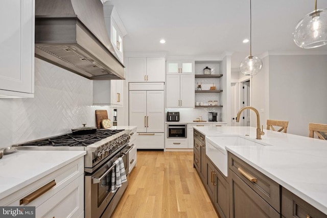 11606 Little Bay Harbor Way, Spotsylvania, VA 22551 - kitchen featuring premium appliances, custom exhaust hood, white cabinets, backsplash, and recessed lighting