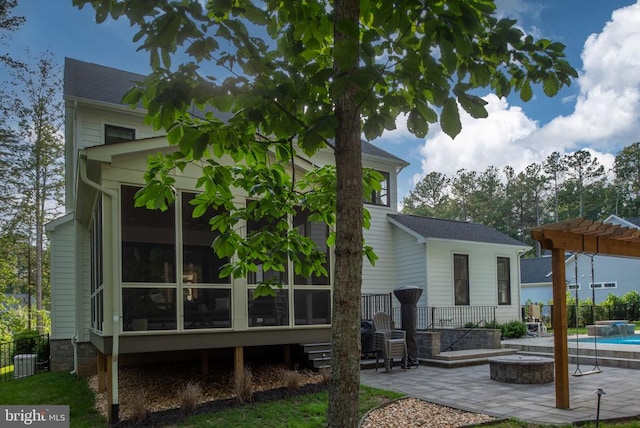 11606 Little Bay Harbor Way, Spotsylvania, VA 22551 - back of house featuring a fire pit, a patio, a sunroom, a pergola, and roof with shingles