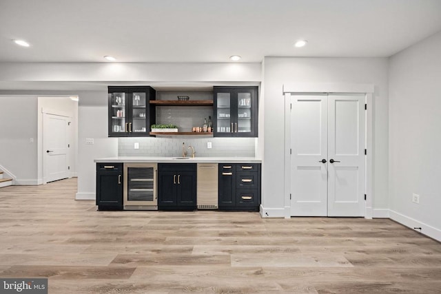 11606 Little Bay Harbor Way, Spotsylvania, VA 22551 - indoor wet bar with wine cooler, decorative backsplash, light wood-style flooring, recessed lighting, and stairs