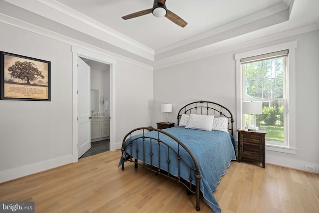 11606 Little Bay Harbor Way, Spotsylvania, VA 22551 - bedroom with light wood-type flooring, crown molding, a tray ceiling, ensuite bath, and a ceiling fan