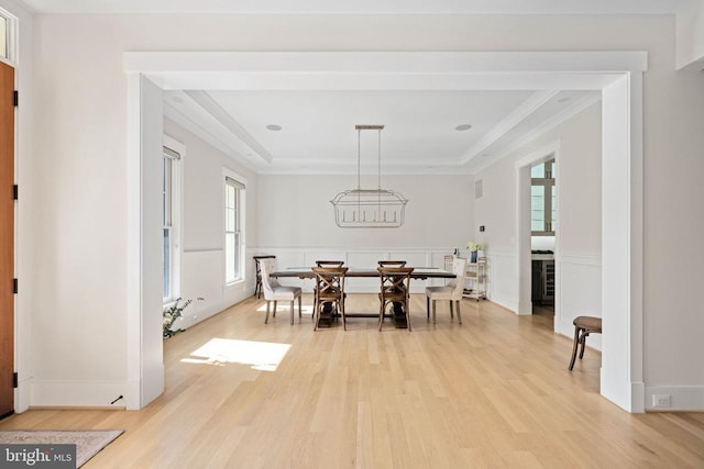 11606 Little Bay Harbor Way, Spotsylvania, VA 22551 - dining room with light wood-style flooring, crown molding, a tray ceiling, wainscoting, and a decorative wall