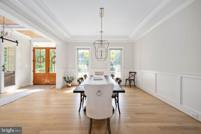 11606 Little Bay Harbor Way, Spotsylvania, VA 22551 - dining room featuring a chandelier, a tray ceiling, a decorative wall, ornamental molding, and light wood finished floors