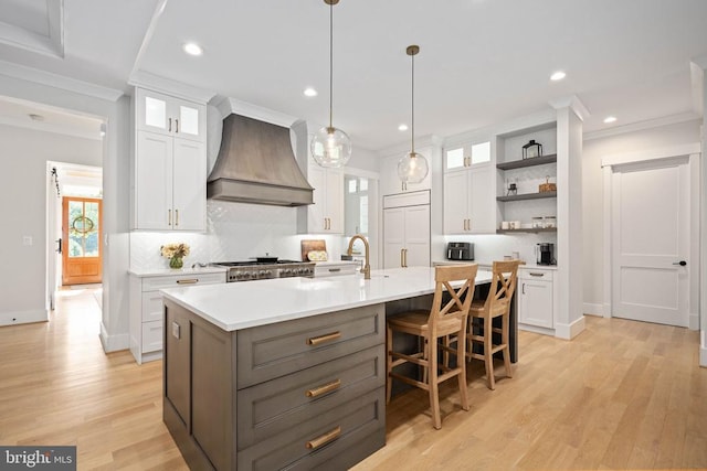 11606 Little Bay Harbor Way, Spotsylvania, VA 22551 - kitchen with custom exhaust hood, open shelves, white cabinetry, tasteful backsplash, and light countertops