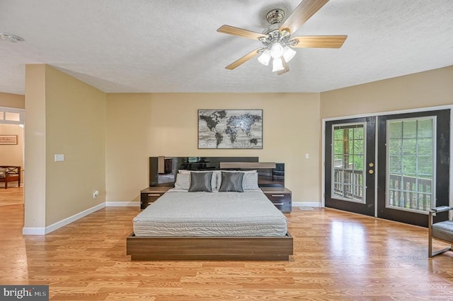 520 Oak Grove Dr, Mineral, VA 23117 - bedroom featuring access to exterior, wood finished floors, baseboards, a textured ceiling, and french doors