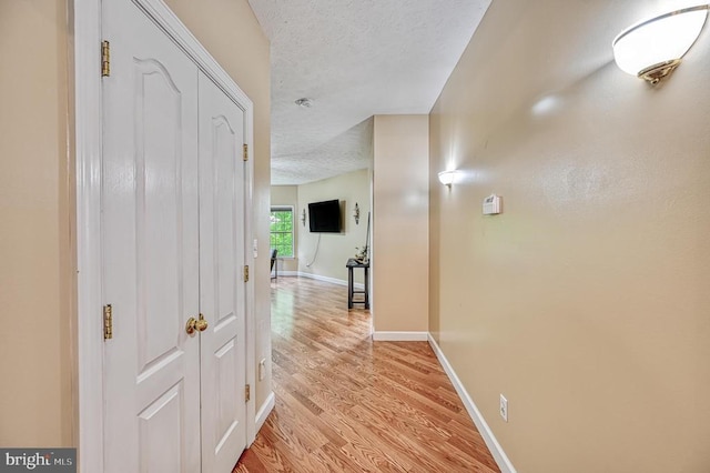 520 Oak Grove Dr, Mineral, VA 23117 - corridor with a textured ceiling, light wood finished floors, and baseboards