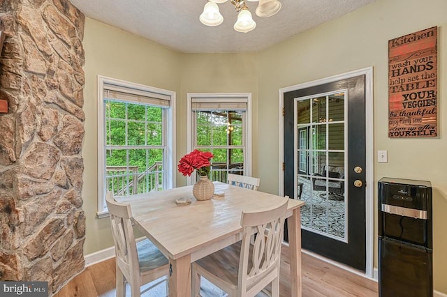 520 Oak Grove Dr, Mineral, VA 23117 - dining area with a chandelier, light wood-style flooring, a textured ceiling, and baseboards