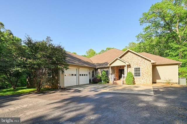 520 Oak Grove Dr, Mineral, VA 23117 - single story home featuring an attached garage, asphalt driveway, stone siding, and central AC