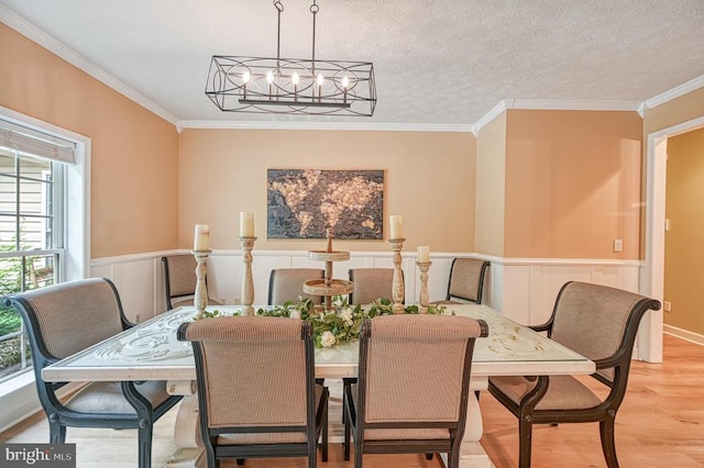 520 Oak Grove Dr, Mineral, VA 23117 - dining room with a chandelier, wood finished floors, ornamental molding, a wainscoted wall, and a decorative wall