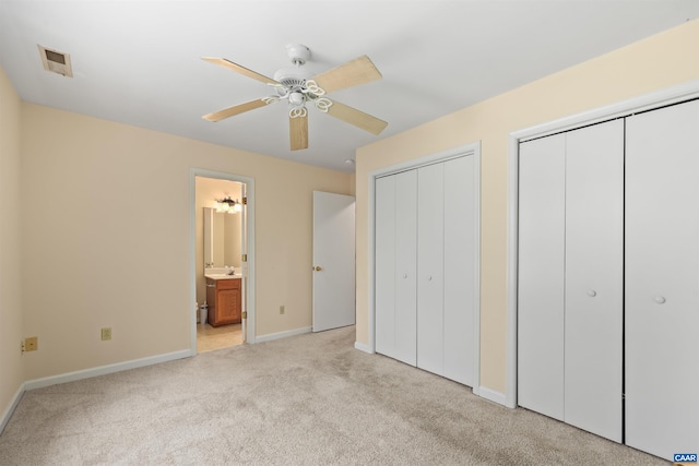 903 Stonehenge Rd, Charlottesville, VA 22901 - unfurnished bedroom featuring two closets, light colored carpet, baseboards, ensuite bath, and a ceiling fan
