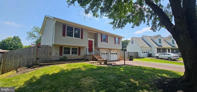 1632 Harrier Ln, Culpeper, VA 22701 - raised ranch featuring driveway, a garage, and brick siding
