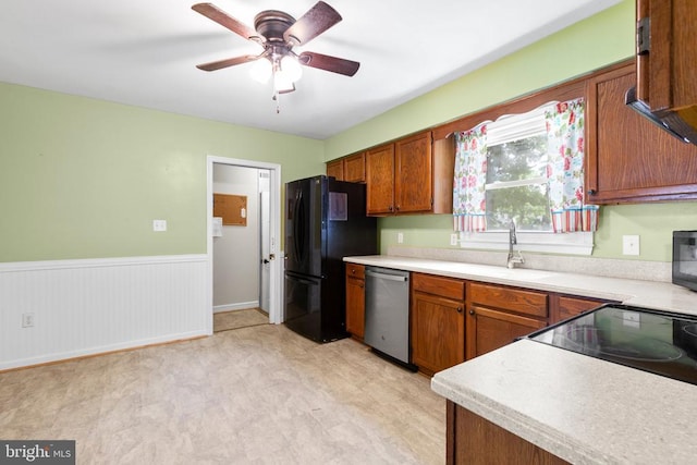 5310 Leavells Crossing Dr, Fredericksburg, VA 22407 - kitchen featuring stainless steel dishwasher, freestanding refrigerator, light countertops, brown cabinets, and wainscoting