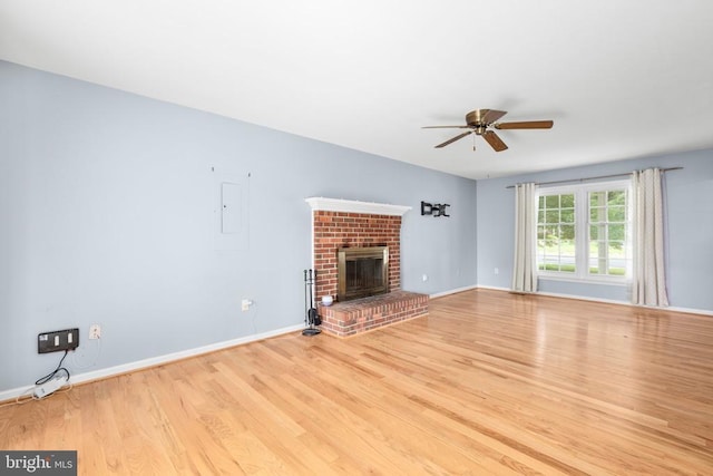 5310 Leavells Crossing Dr, Fredericksburg, VA 22407 - unfurnished living room with a ceiling fan, light wood finished floors, a fireplace, and electric panel