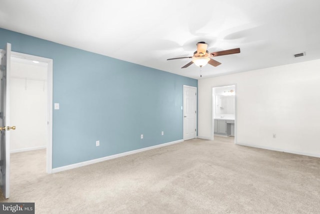 5310 Leavells Crossing Dr, Fredericksburg, VA 22407 - unfurnished bedroom with light colored carpet, a walk in closet, a closet, connected bathroom, and a ceiling fan