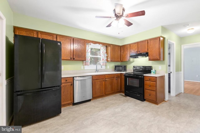 5310 Leavells Crossing Dr, Fredericksburg, VA 22407 - kitchen featuring black appliances, under cabinet range hood, light countertops, and brown cabinets