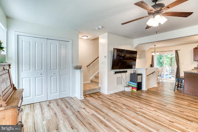 1905 Crepe Myrtle Ln, Culpeper, VA 22701 - unfurnished living room with light wood-style floors, a ceiling fan, and stairs