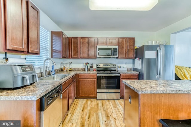 1905 Crepe Myrtle Ln, Culpeper, VA 22701 - kitchen with appliances with stainless steel finishes, light wood finished floors, light countertops, and brown cabinetry