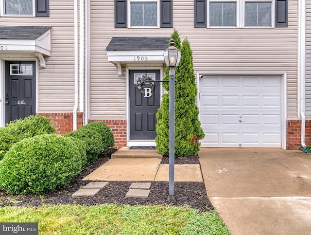 1905 Crepe Myrtle Ln, Culpeper, VA 22701 - view of exterior entry featuring an attached garage, brick siding, and driveway