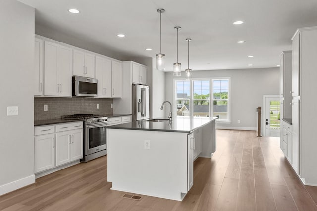 3247 Preston Shore Dr Unit 18D, Rockingham, VA 22801 - kitchen with stainless steel appliances, dark countertops, light wood-type flooring, an island with sink, and recessed lighting