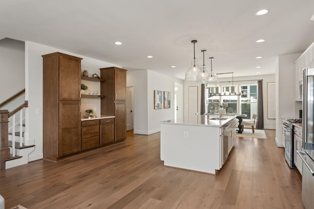 3247 Preston Shore Dr Unit 18D, Rockingham, VA 22801 - kitchen with stainless steel gas range oven, a kitchen island with sink, light countertops, wood finished floors, and recessed lighting