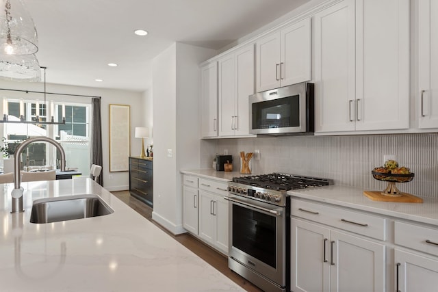 3247 Preston Shore Dr Unit 18D, Rockingham, VA 22801 - kitchen with appliances with stainless steel finishes, a sink, decorative backsplash, white cabinetry, and dark wood finished floors