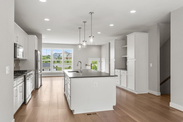 3247 Preston Shore Dr Unit 18D, Rockingham, VA 22801 - kitchen featuring high end appliances, a sink, dark countertops, an island with sink, and recessed lighting