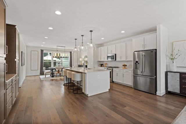 3247 Preston Shore Dr Unit 18D, Rockingham, VA 22801 - kitchen featuring stainless steel appliances, recessed lighting, dark wood finished floors, a center island with sink, and light countertops