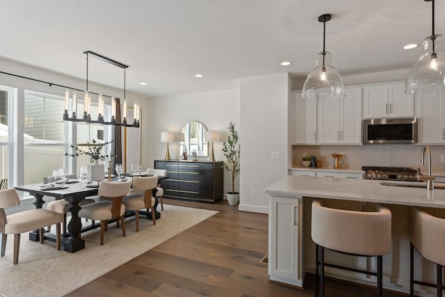 3247 Preston Shore Dr Unit 18D, Rockingham, VA 22801 - kitchen with stainless steel microwave, a sink, tasteful backsplash, white cabinets, and recessed lighting