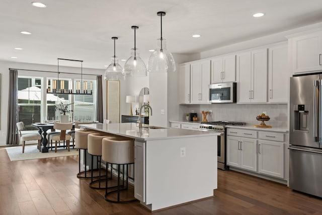 3247 Preston Shore Dr Unit 18D, Rockingham, VA 22801 - kitchen featuring appliances with stainless steel finishes, a sink, a center island with sink, white cabinetry, and backsplash