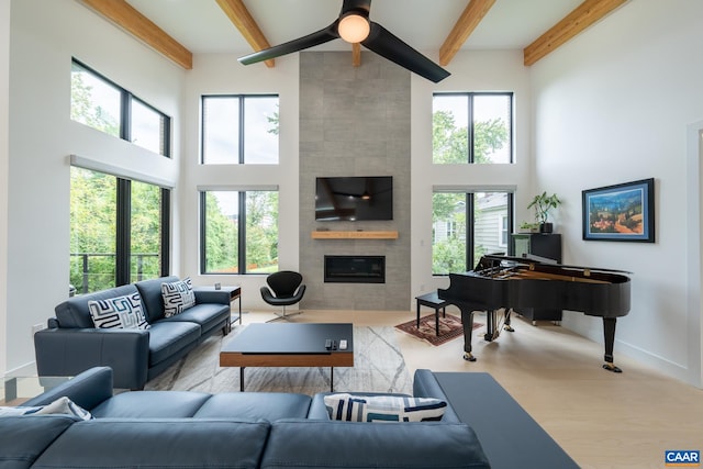 320A 11th St NE, Charlottesville, VA 22902 - living room with a towering ceiling, a tile fireplace, ceiling fan, beam ceiling, and baseboards