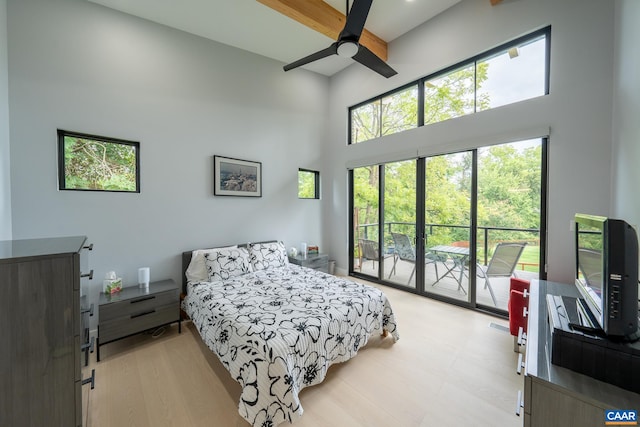 320A 11th St NE, Charlottesville, VA 22902 - bedroom featuring a towering ceiling, access to outside, multiple windows, ceiling fan, and light wood finished floors