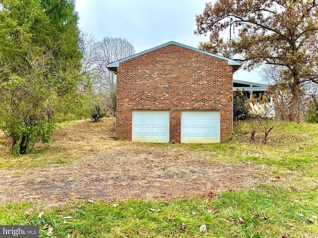 view of side of home with a garage and an outdoor structure