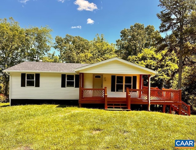 view of front of house with roof with shingles and a front yard