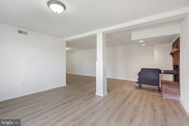 finished basement with light wood-style flooring, baseboards, visible vents, and recessed lighting