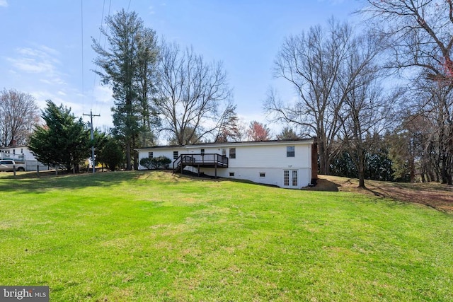 view of yard featuring stairs, a deck, and french doors