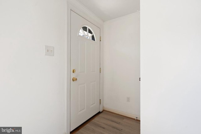entryway featuring wood finished floors and ornamental molding