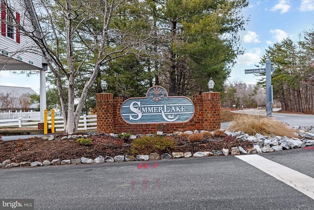 community sign featuring fence