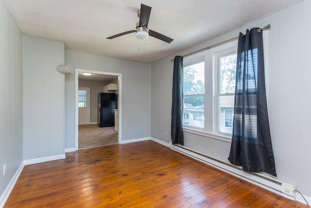 99 Sharp Hill Ln, Hinton, VA 22831 - spare room with baseboard heating, hardwood / wood-style floors, and ceiling fan